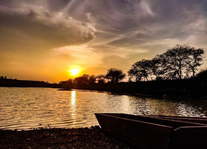 Golden-hour riverside photo with a boat, part of Pragati's personal photography