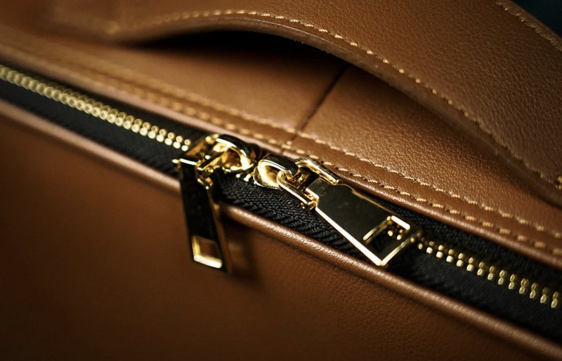 Luxury bag zipper detail shot, reference for teaser-style close-up photography