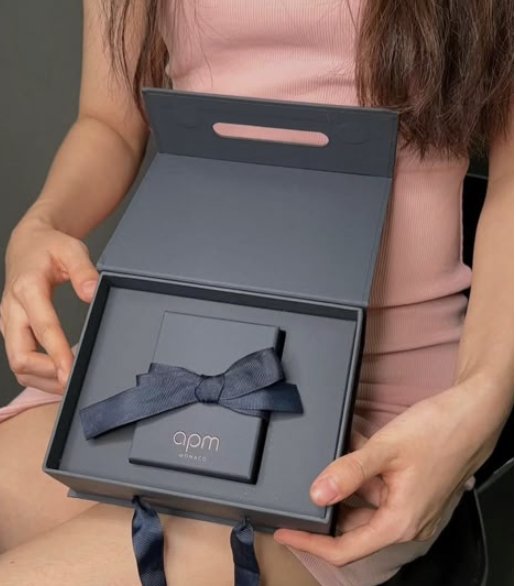 Personalized gift box tied with a black ribbon bow
