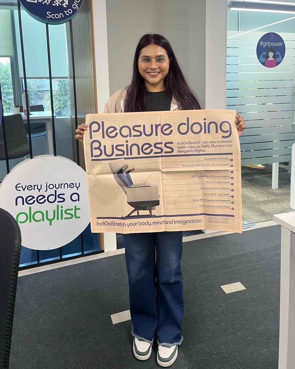 Pragati Khare holding the printed 'Pleasure doing Business' launch asset she wrote the specs for