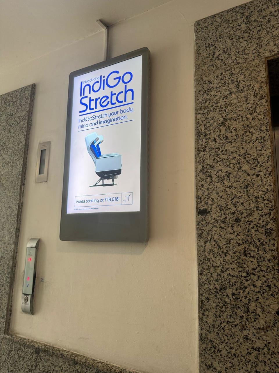 IndiGoStretch digital signage in an office elevator lobby